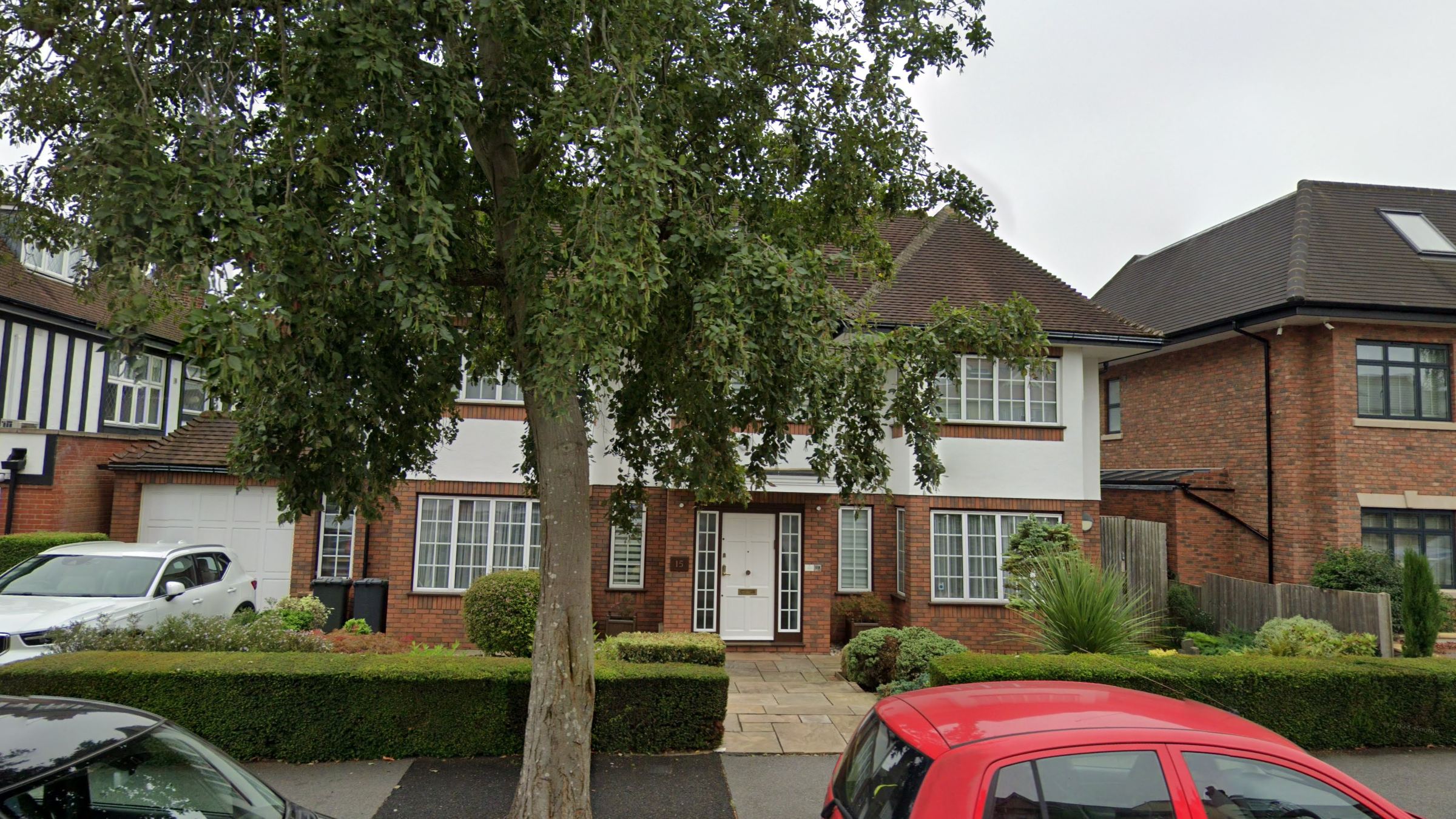 Front elevation of 15 Cranbourne Gardens: red-brick ground floor, white render above and a white panelled front door